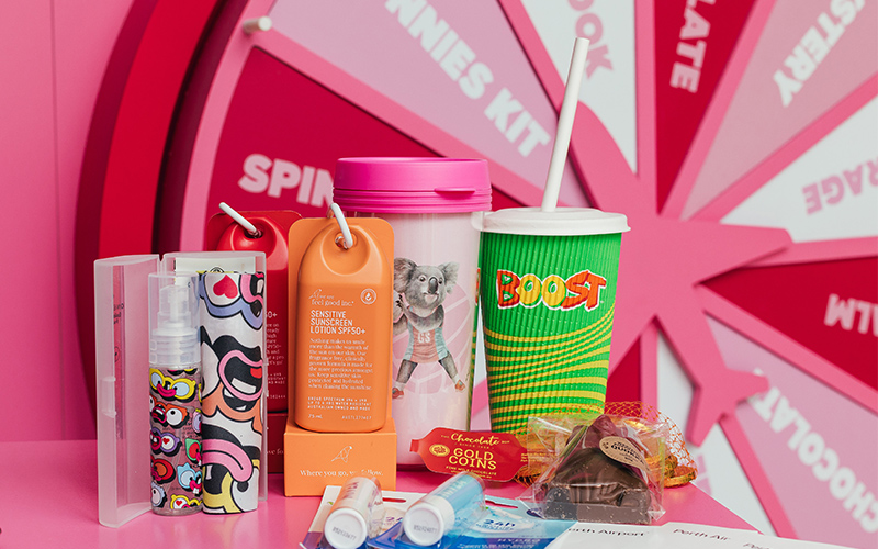 Assorted Ticket to Win prizes including sunscreen and travel cup