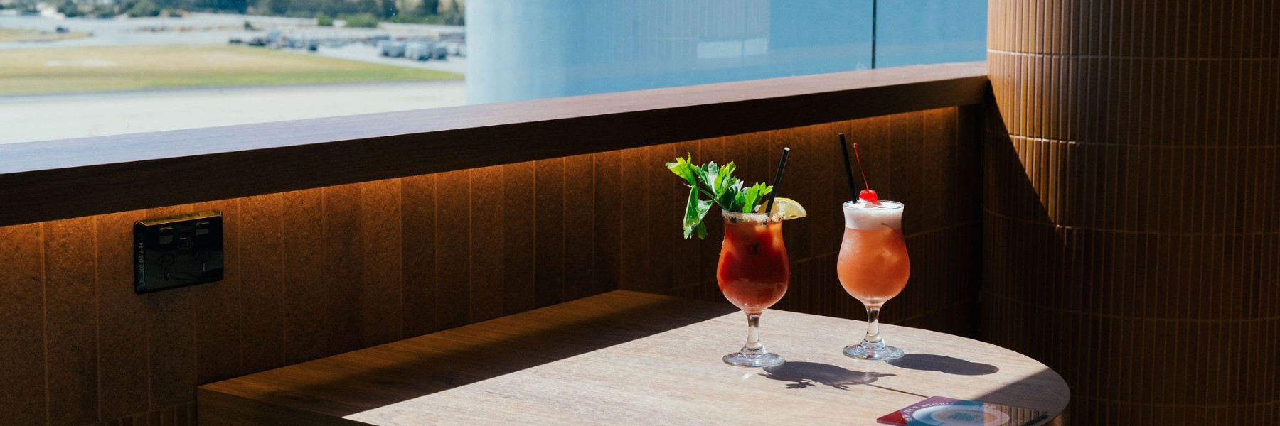 Two tropical cocktails at Co and Co overlooking the Perth Airport runway 