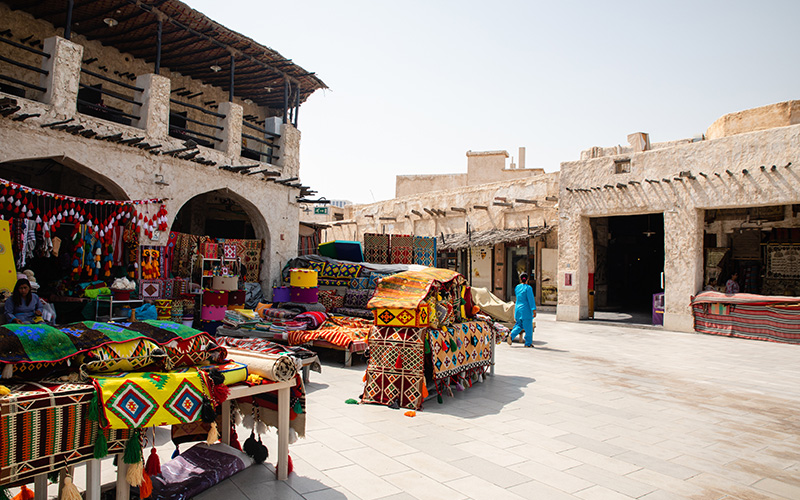 Market stall selling traditional fabrics at Souk Waqif