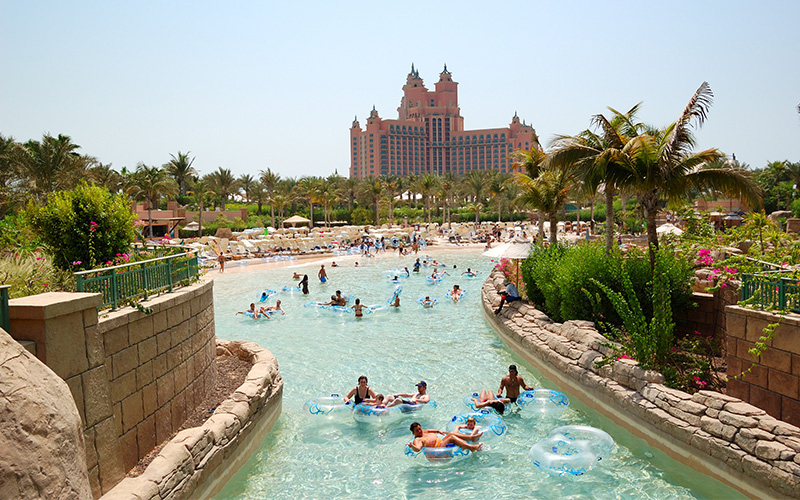People floating in rings on a pool at Aquaventure World in Dubai 
