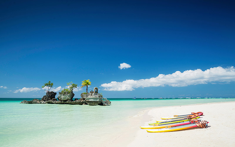 Stand-up paddleboard along Boracay‘s powdery white shores in the Philippines